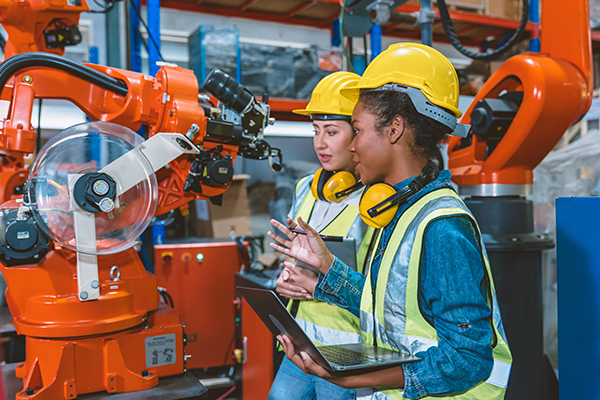 Factory workers using new machinery