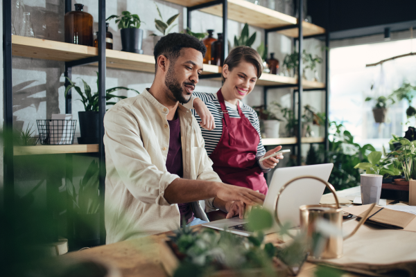 business owner and employee in plant store